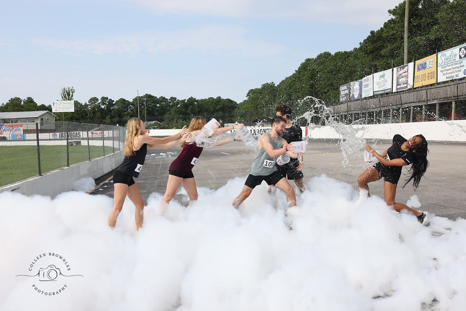 Excited children playing in a mountain of bubbles at a Foam Party by Emerald Owl Productions.